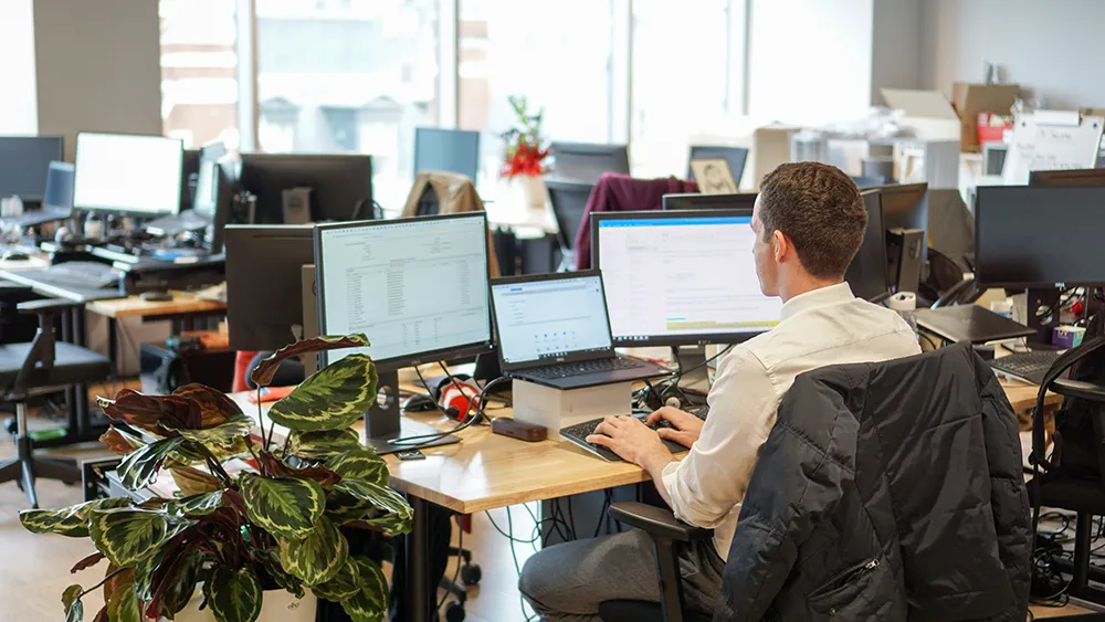 Financial services male worker in an office using Dynamics 365